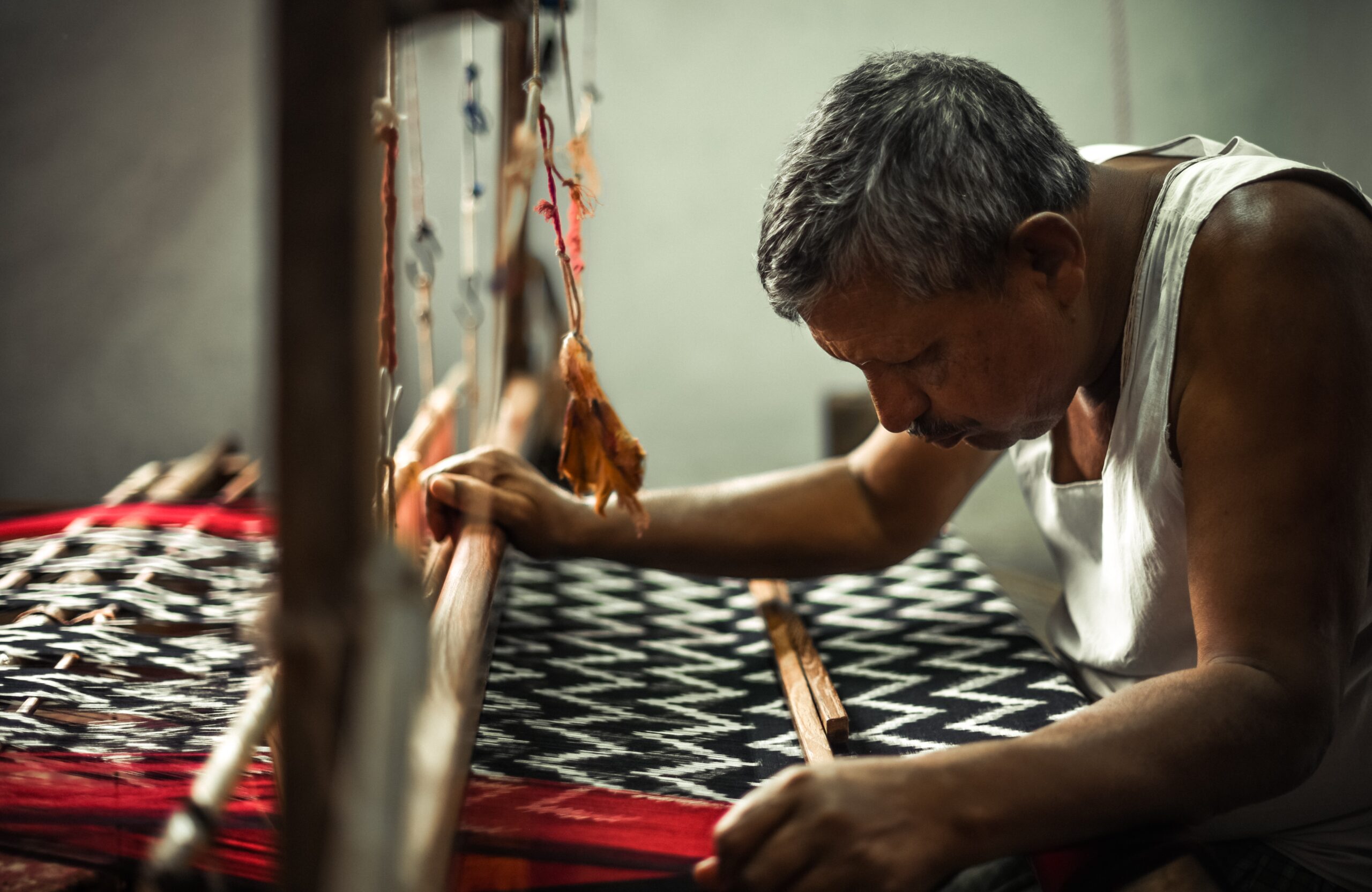 a man working on a handloom